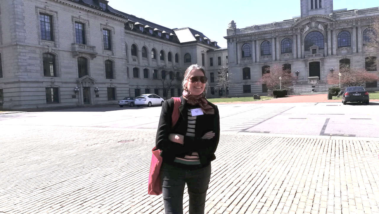 A woman stood in front of a grand building