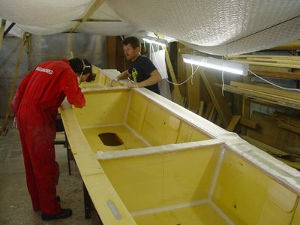 Michael and John working on unpainted Amatasi hull in workshop