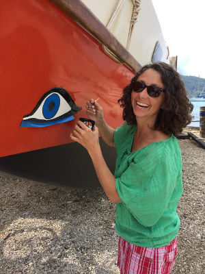 Casey repainting an eye on the hull