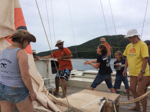 The crew hoisting sails