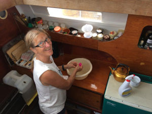Hanneke in the galley with a wash bowl