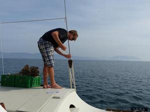 Pierre-Yves adjusting a lanyard whil Gaia is out at sea