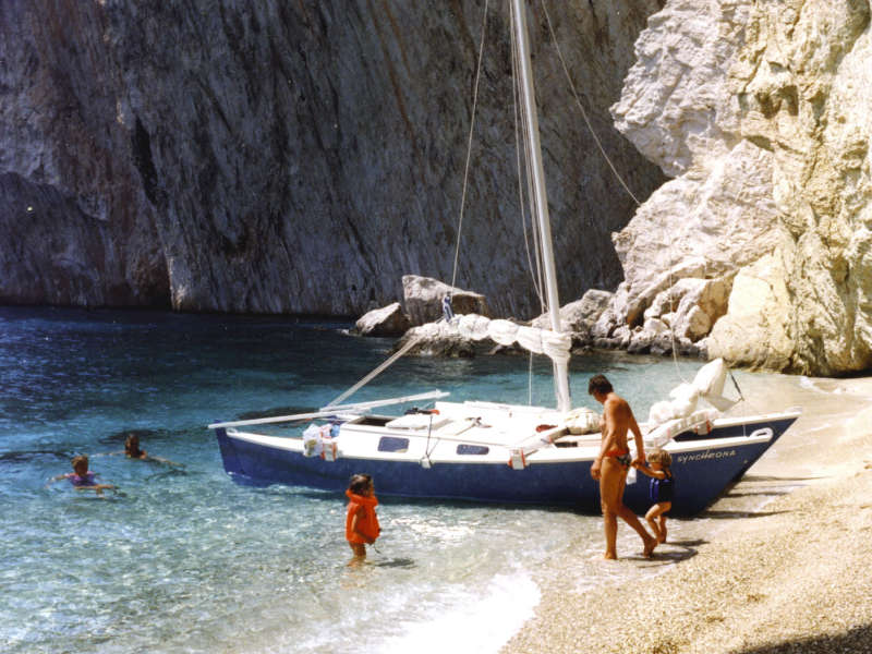 Catamaran on the beach, an adult and several children