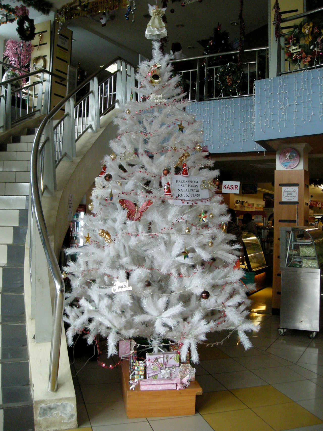 Large christmas tree next to a staircase