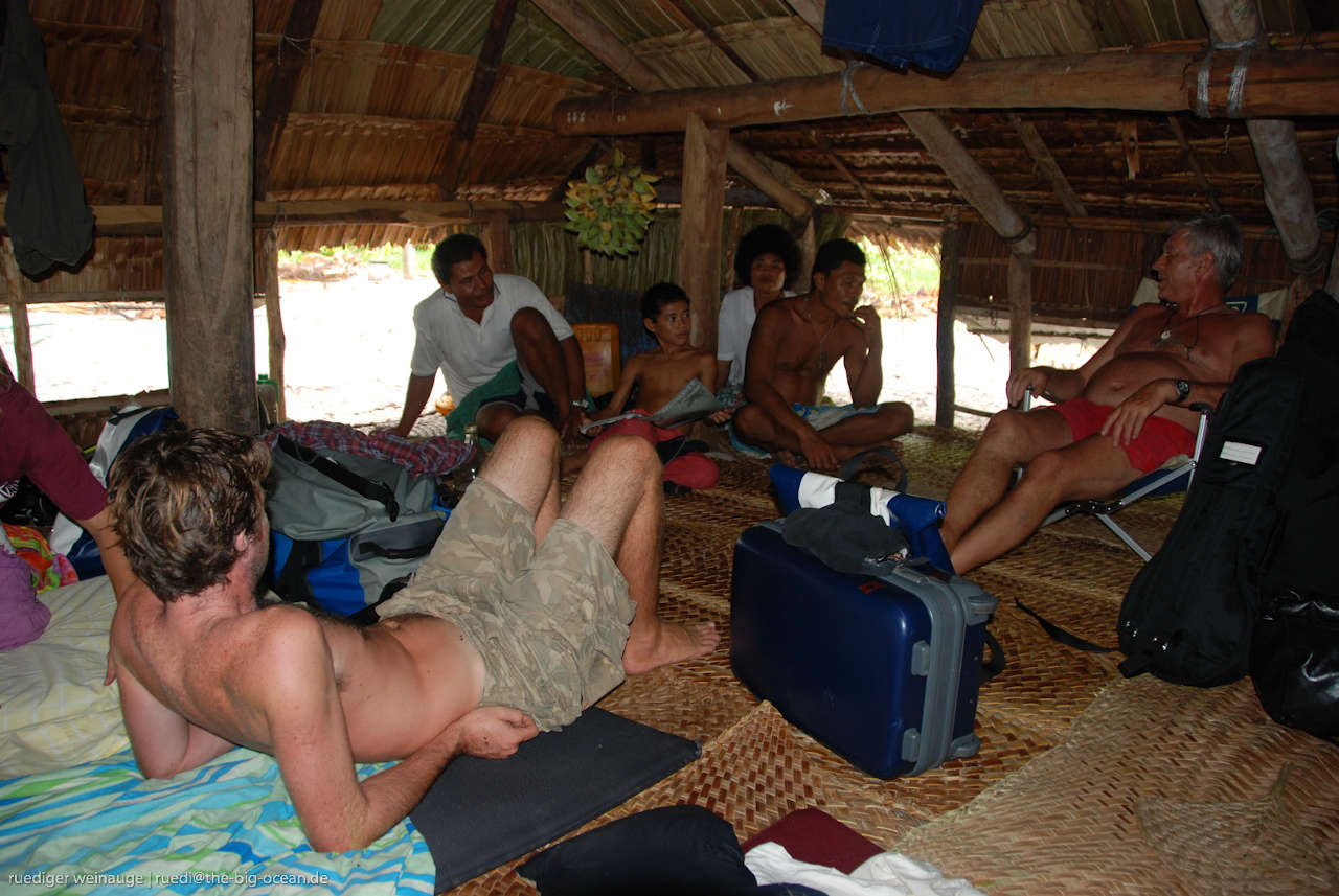 People relaxing in a beach house with low entrances