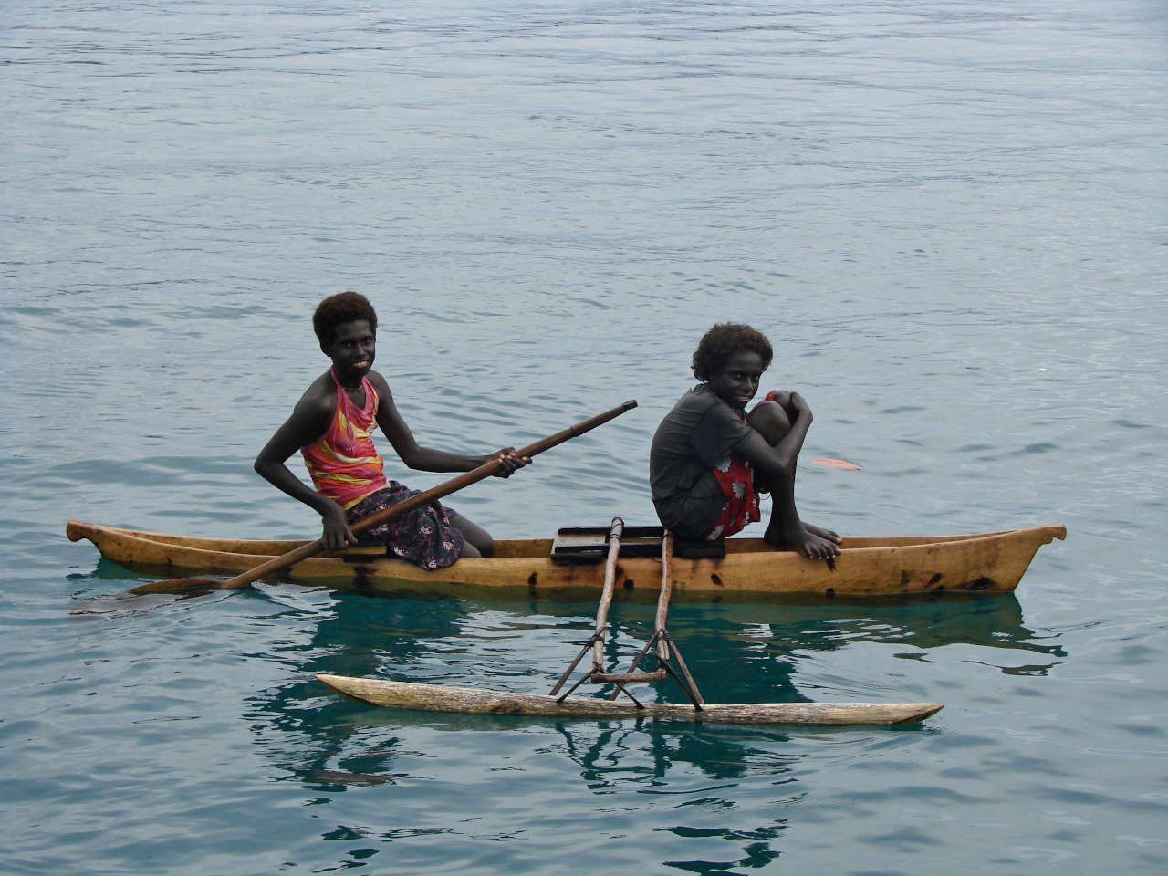 Local girls in an outrigger canoe