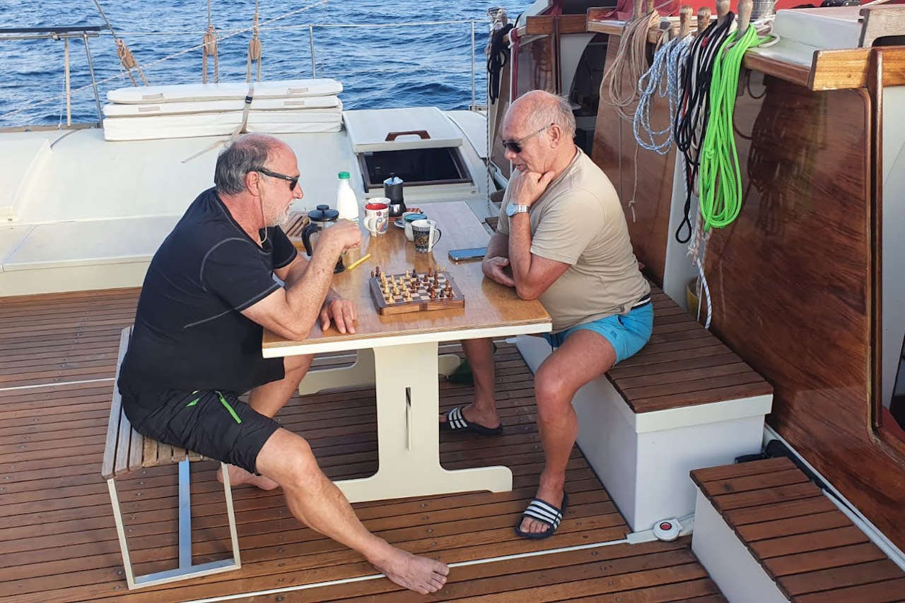 Crew members playing chess on deck
