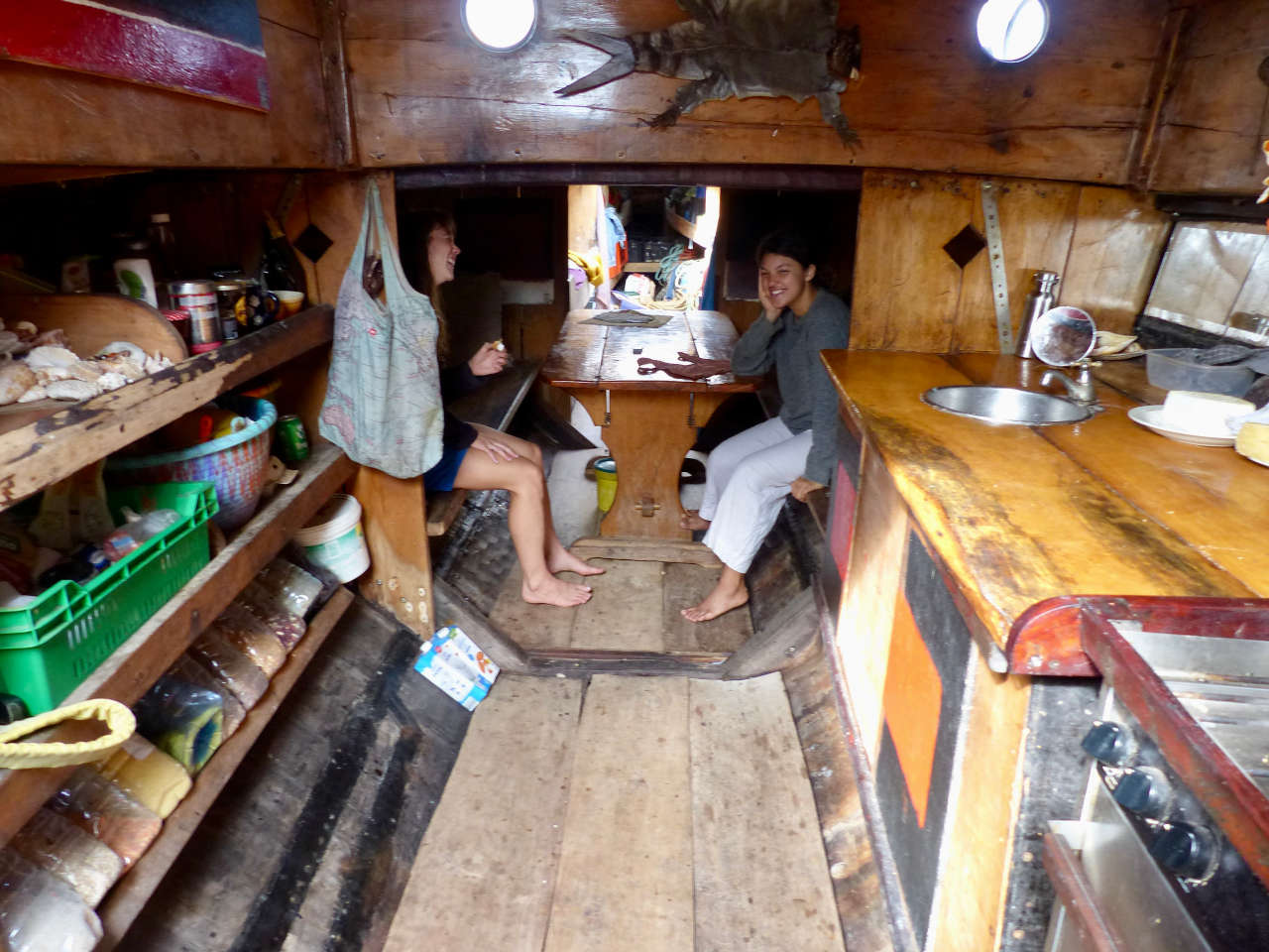 Two women sat at a galley table below decks