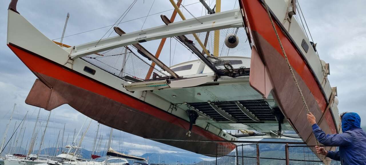 A large catamaran suspended in the air
