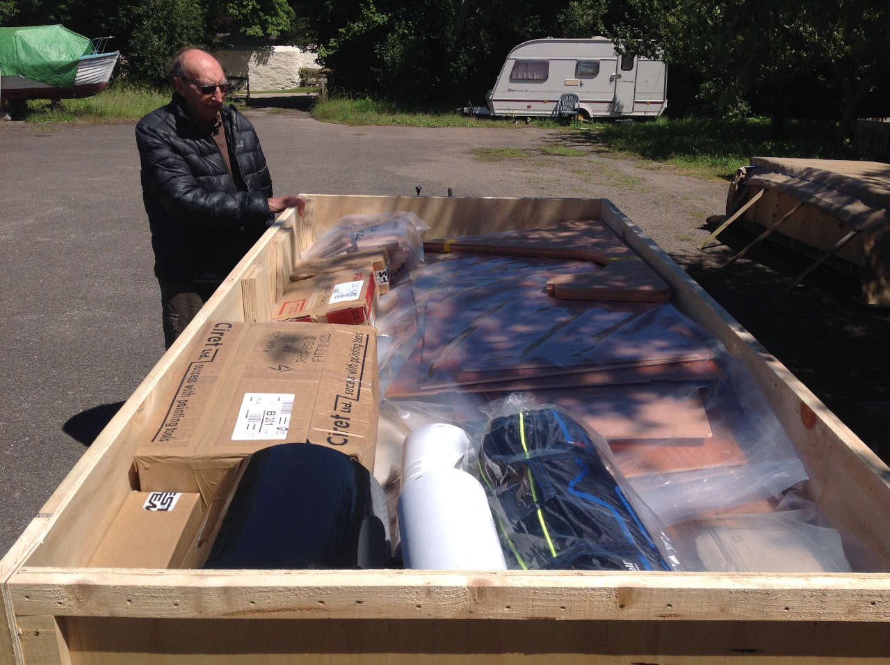 A big box full of plywoood parts and other boat components