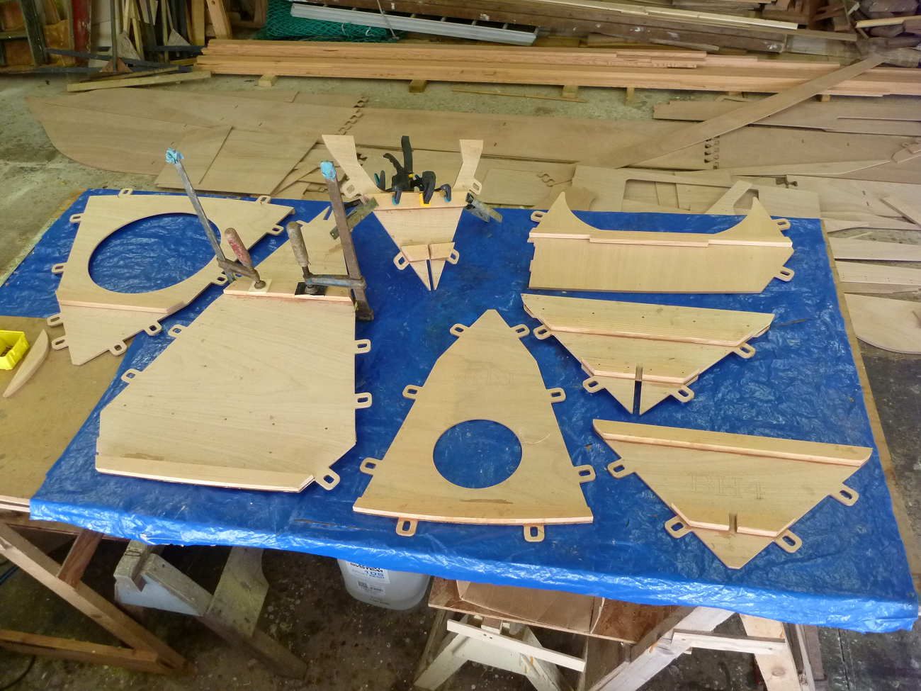 Mana 24 pre-cut plywood parts on a work bench