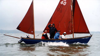 Drascombe Lugger with red sails