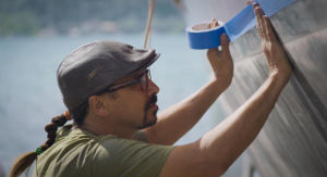 Shawn applying masking tape to the hull