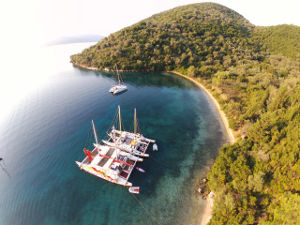 Arial view of two catamarans moored in a beautiful bay