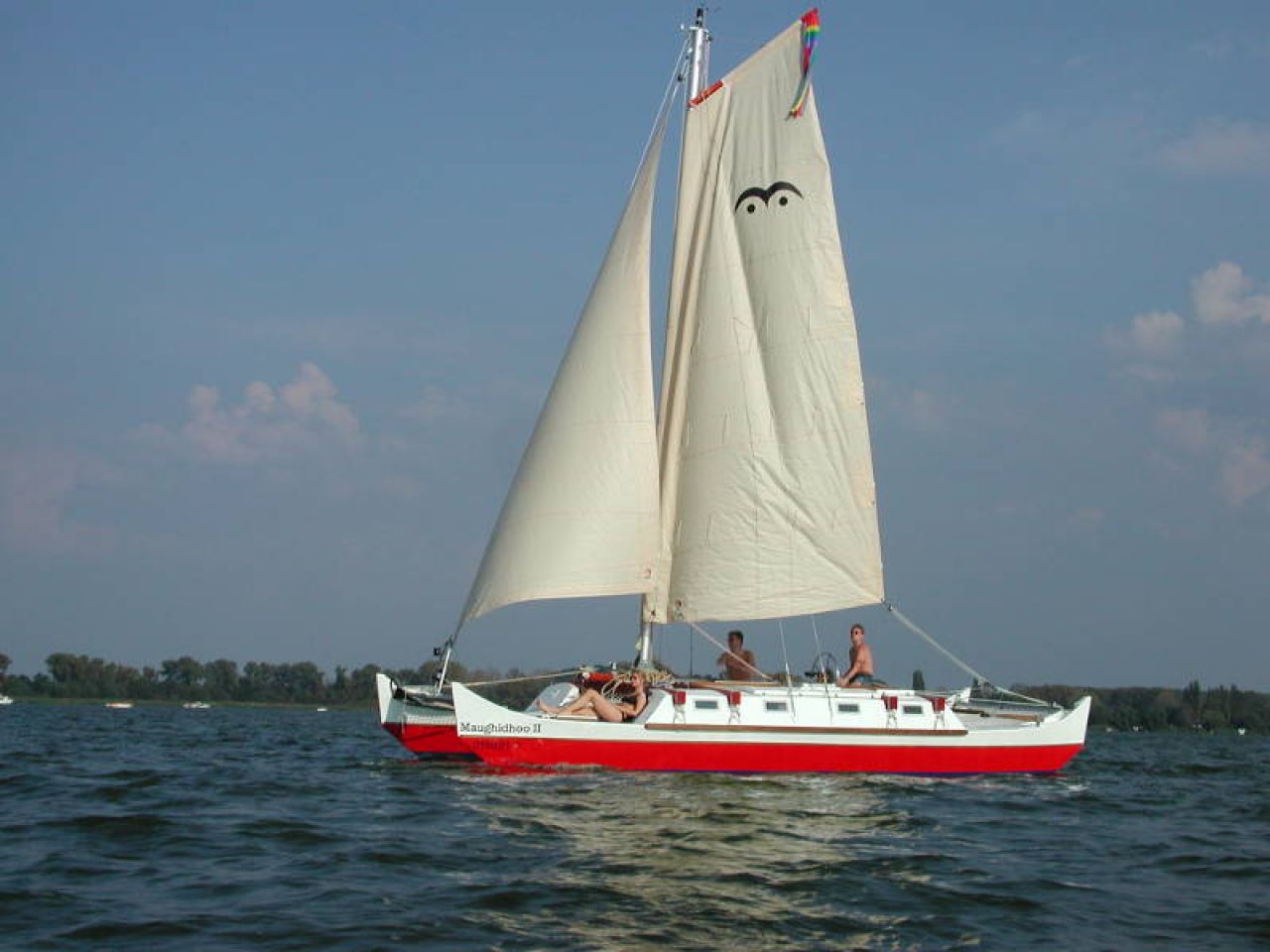 Red and white catamaran sailing