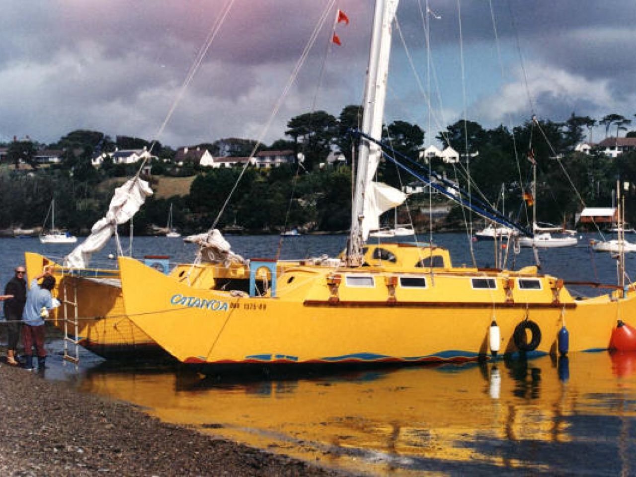 Beached yellow catamaran