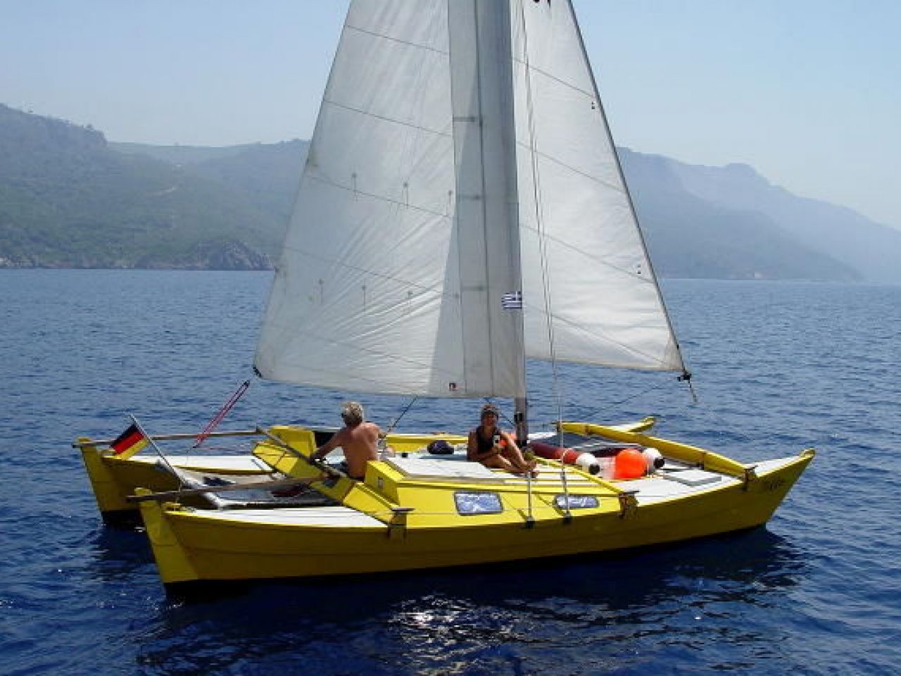 Yellow catamaran sailing