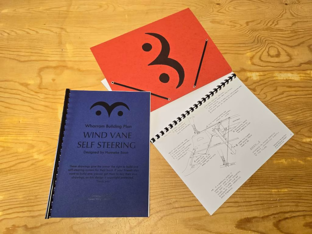 Two booklets, one open showing diagrams, the other closed showing booklet title