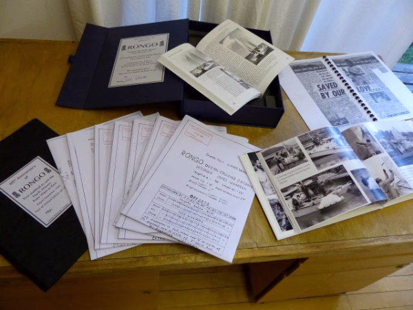 Books, plan sheets and photos on a table