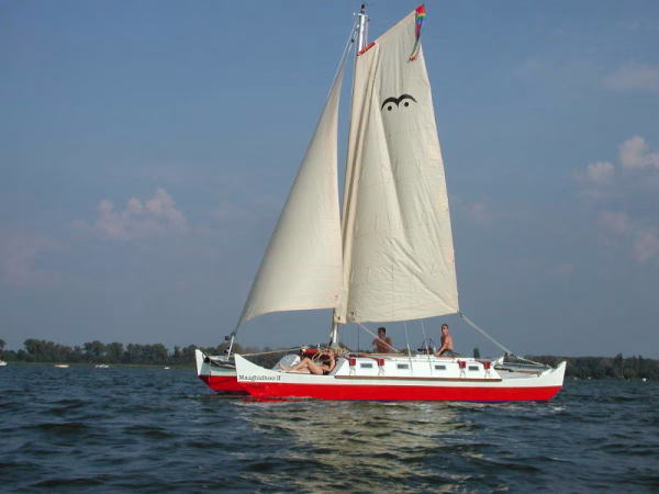 Red and white sailing catamaran