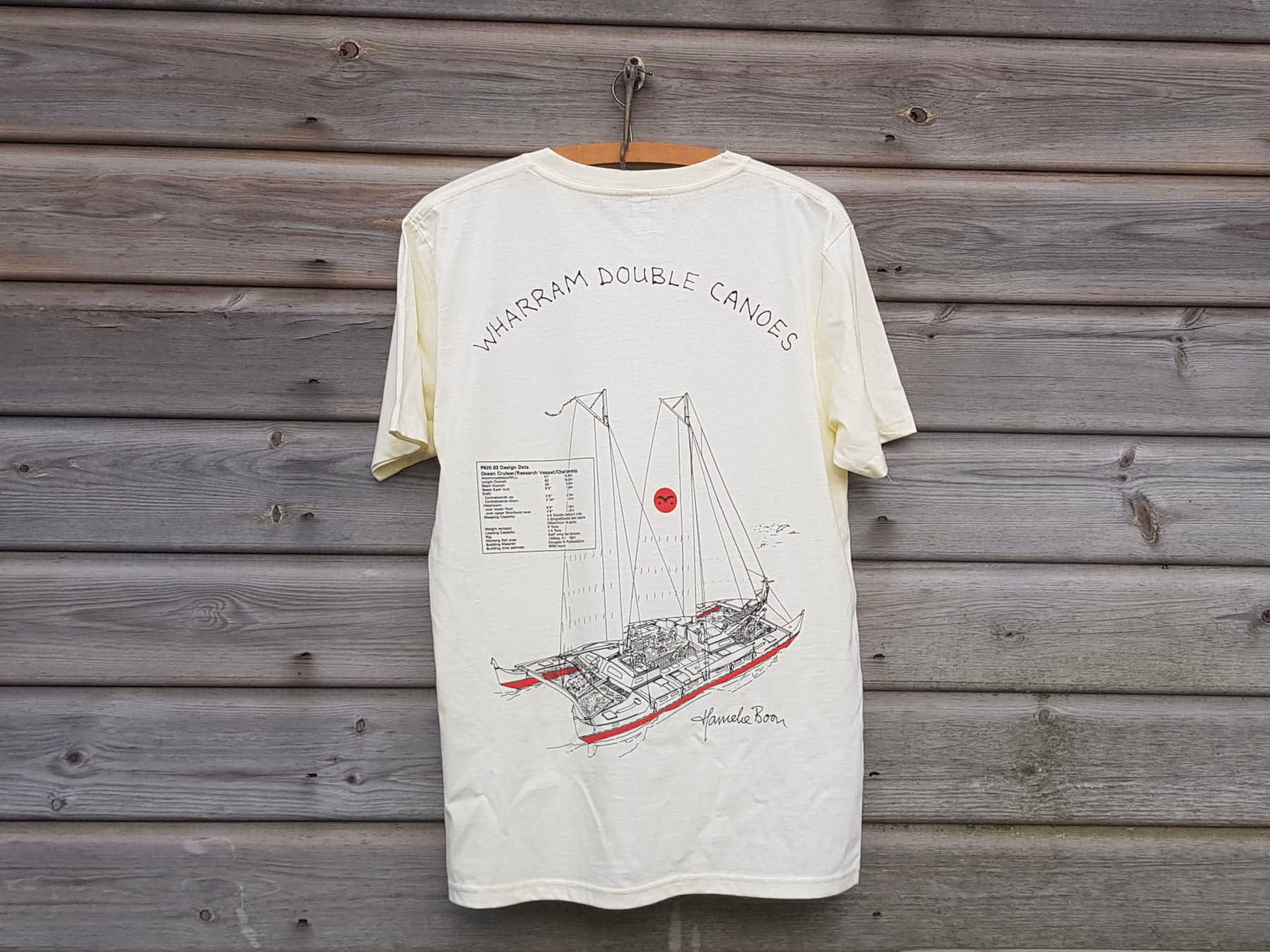 White T-shirt with a boat on it, on a clothes hanger