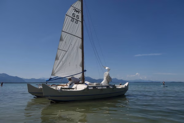 Small white catamaran sailing