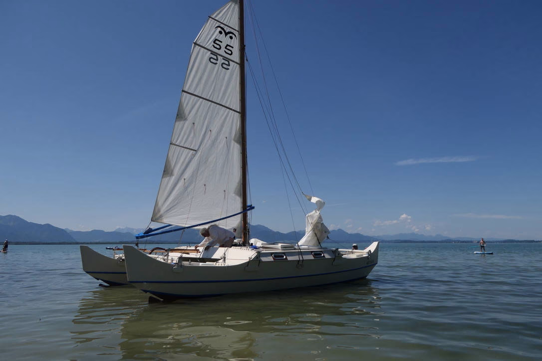 Small white catamaran sailing