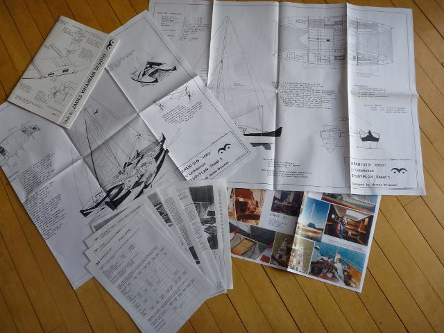 Papers and articles spread out on a surface.