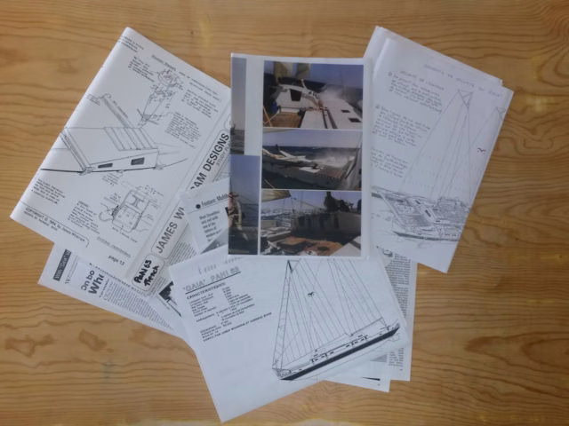 Papers and articles spread out on a surface.