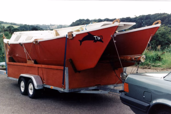 Red catamaran on a car trailer