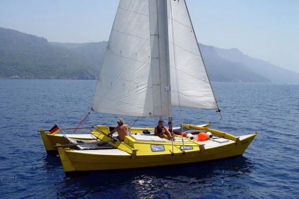 Yellow catamaran under sail