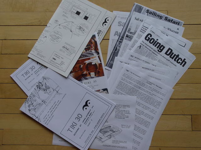 Papers and articles spread out on a surface.